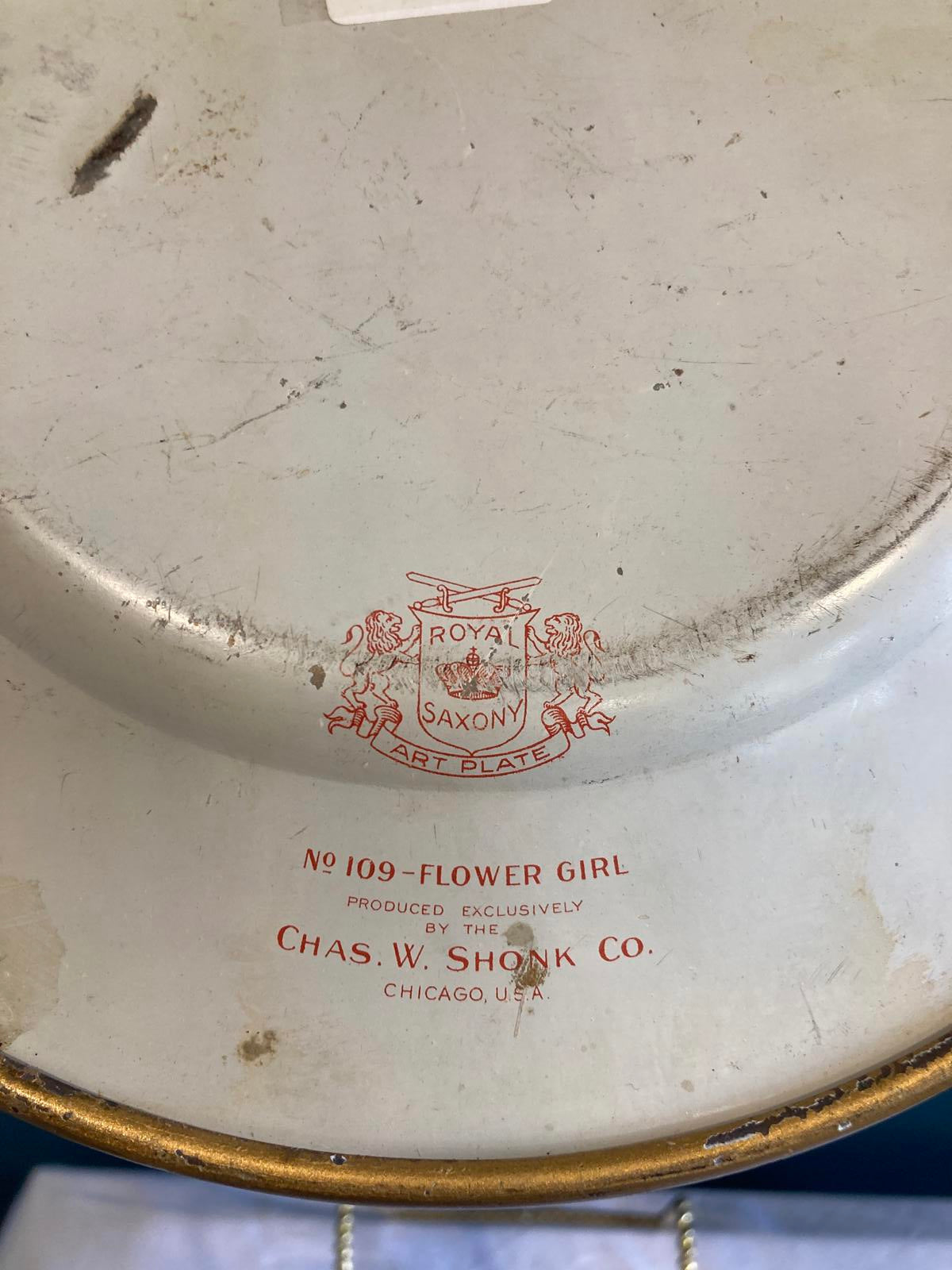 Royal Saxony “Flower Girl” Decorative Metal Plate by Chas W. Shonk Co. Chicago