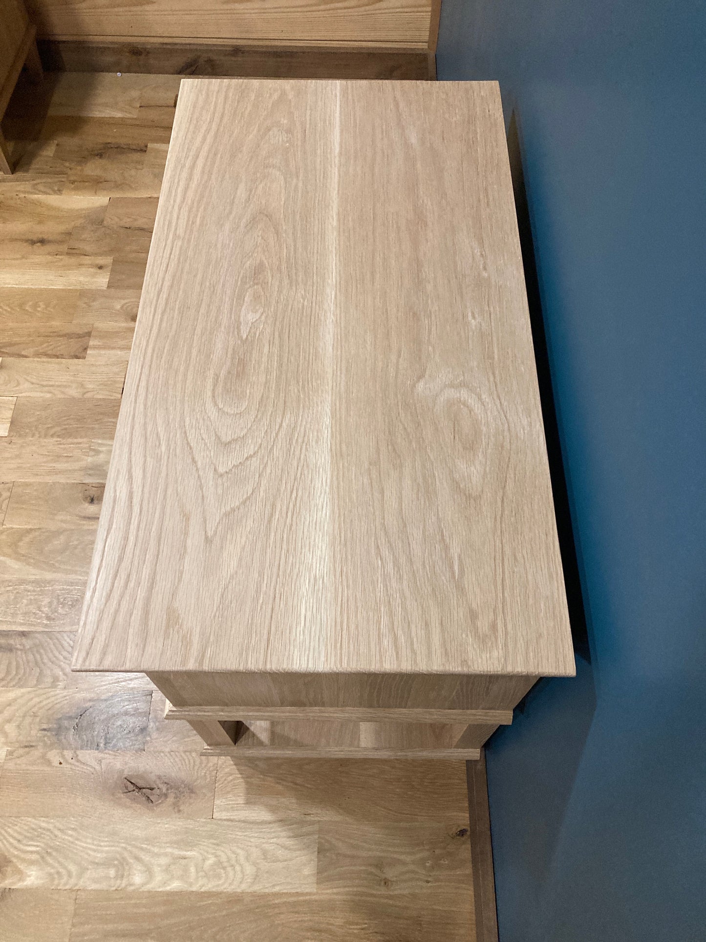 Top of a solid oak nightstand with wood grain details showing.