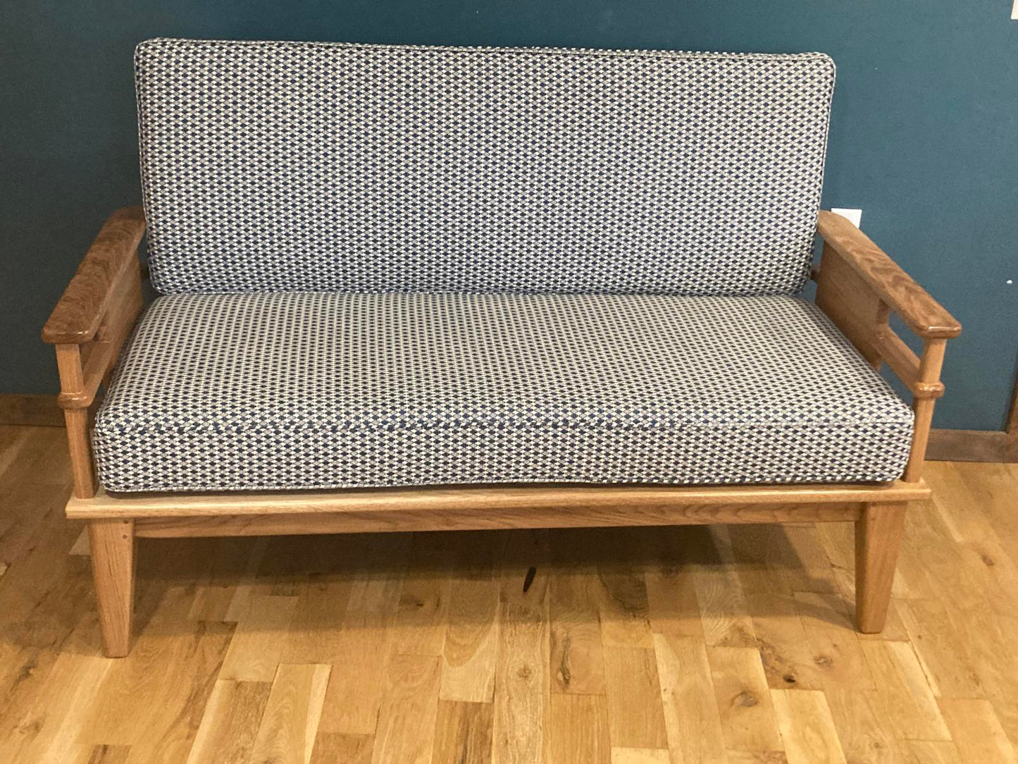 Solid wood handmade couch with upholsered cushions.