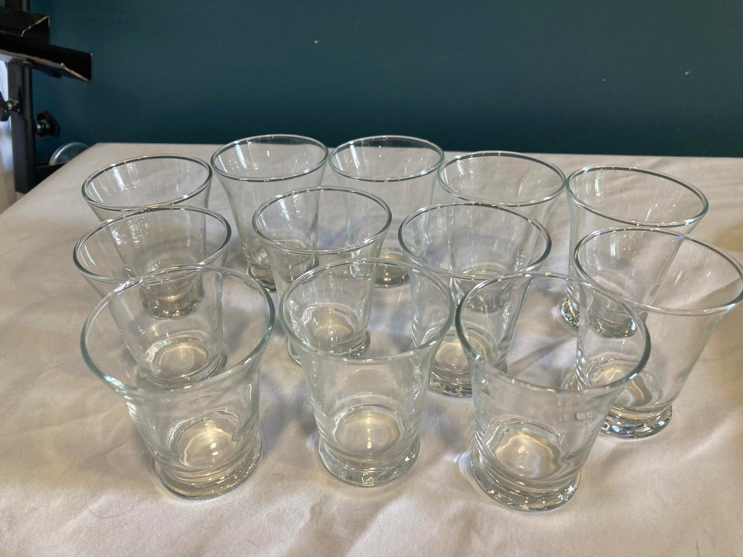 Set of clear glass cups on a white surface