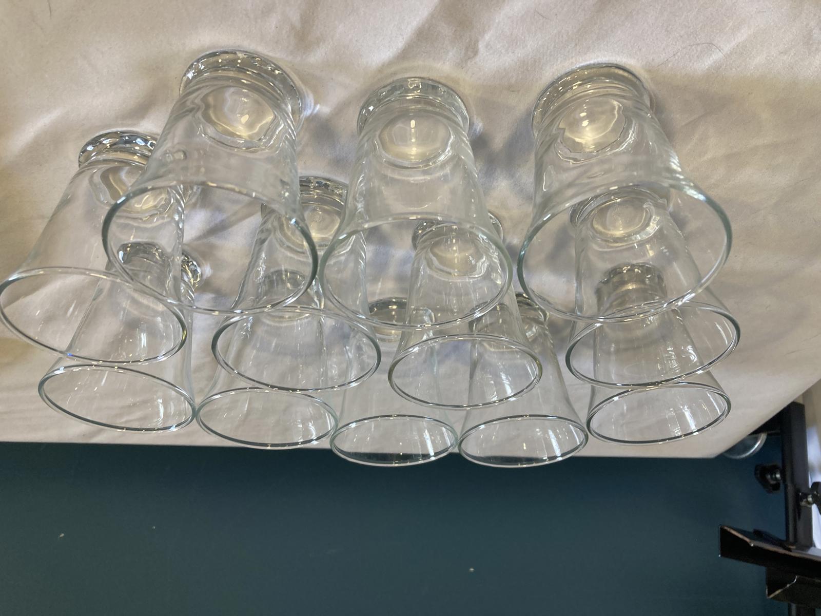 Set of clear glass cups on a white surface