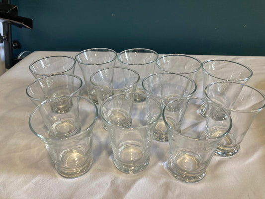 Set of clear glass cups on a white surface