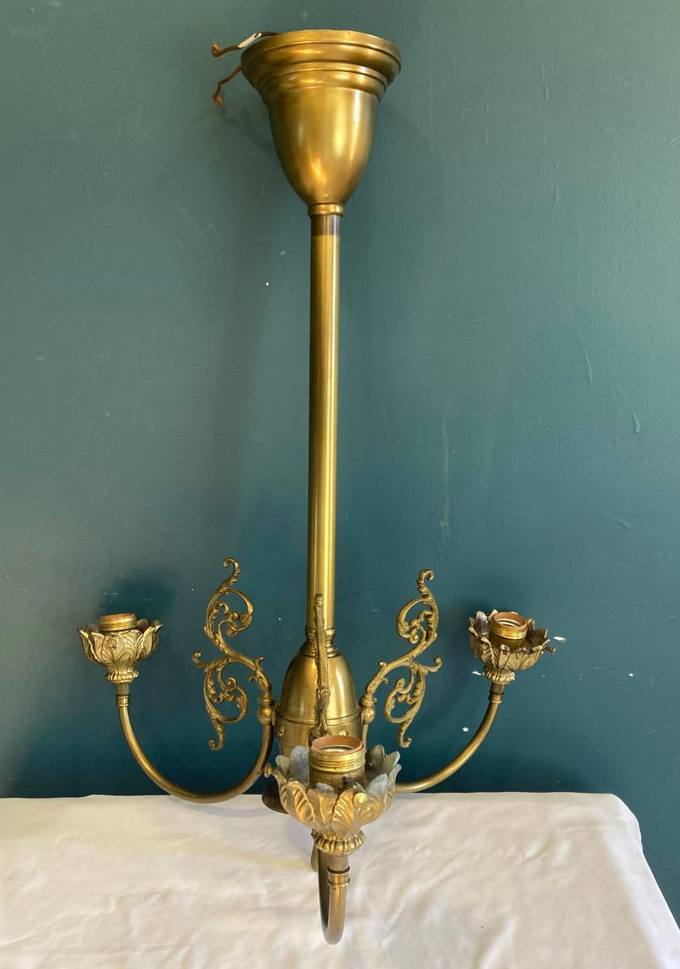 Decorative brass lamp with intricate design on a green surface