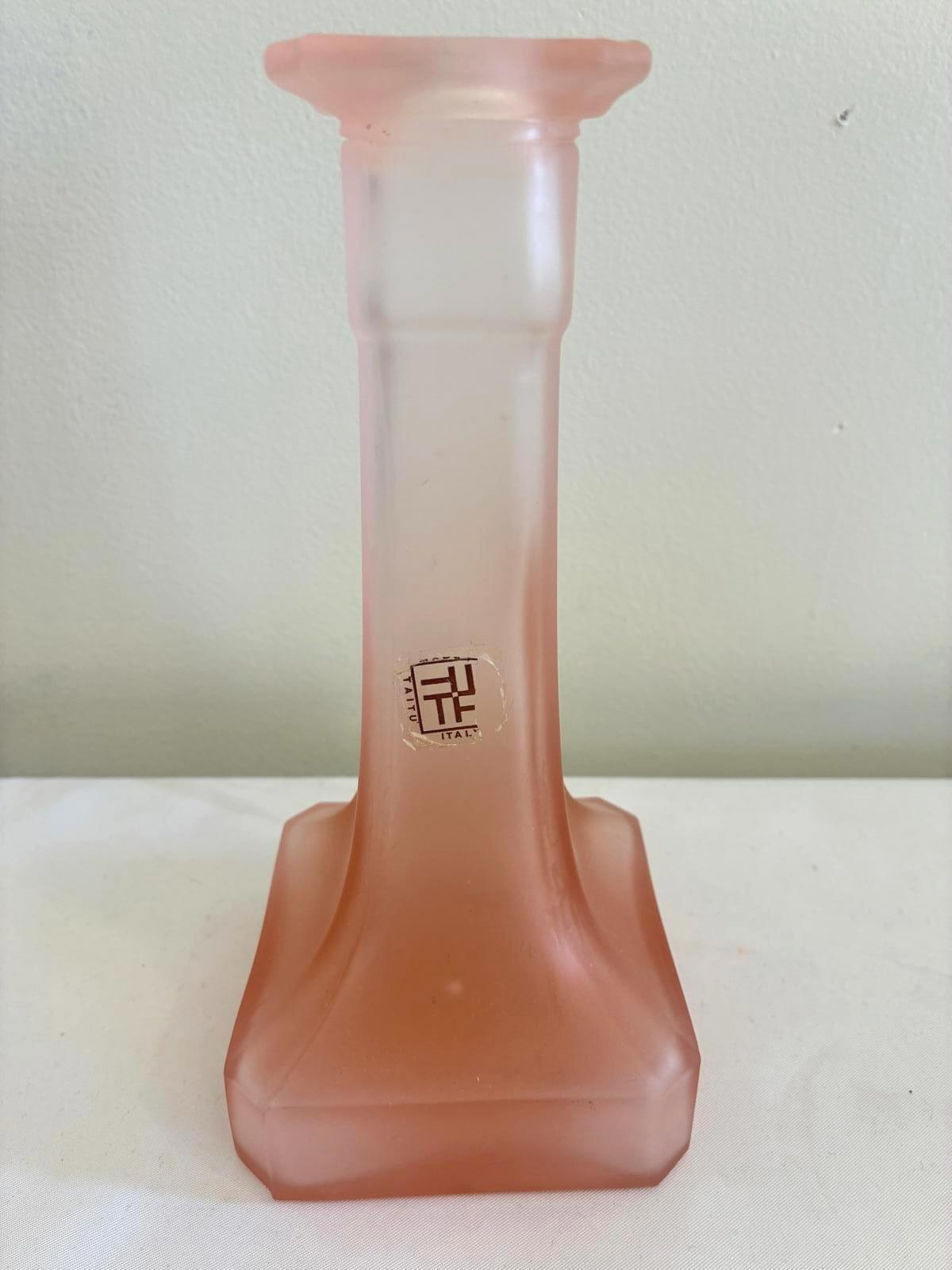 Pink candleholder marked Made in Italy.  It is sitting on a white background. 