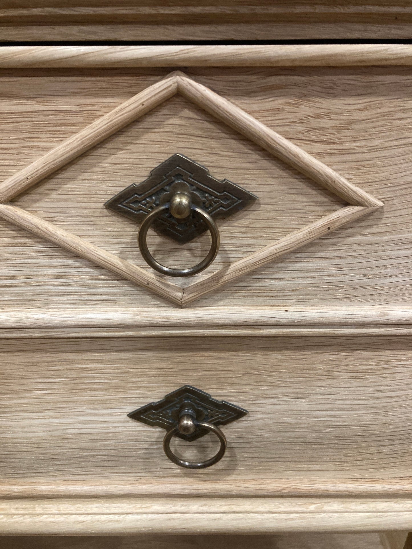 Close up view of diamond detail on drawer and the vintage looking drawer pulls. 