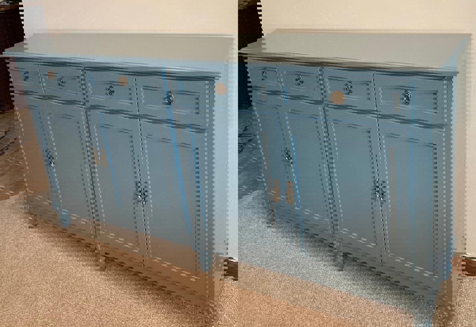 A light blue wooden cabinet with four doors and four drawers. The cabinet has brass handles and sits on four hand turned legs.
