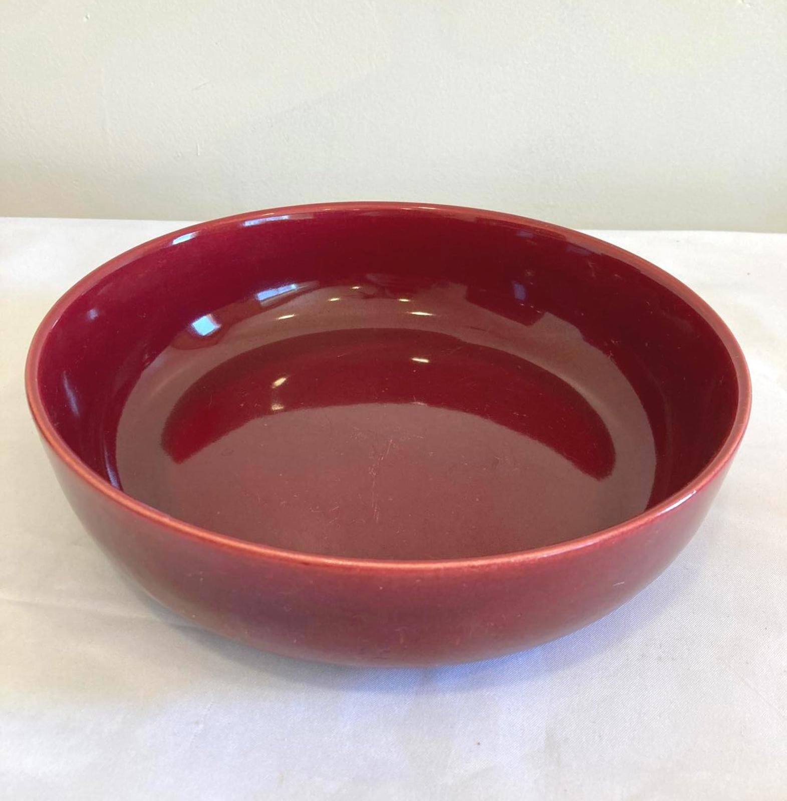 Red ceramic bowl on a white background