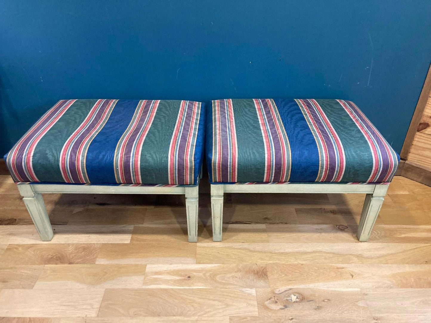 Two striped stools with a blue background