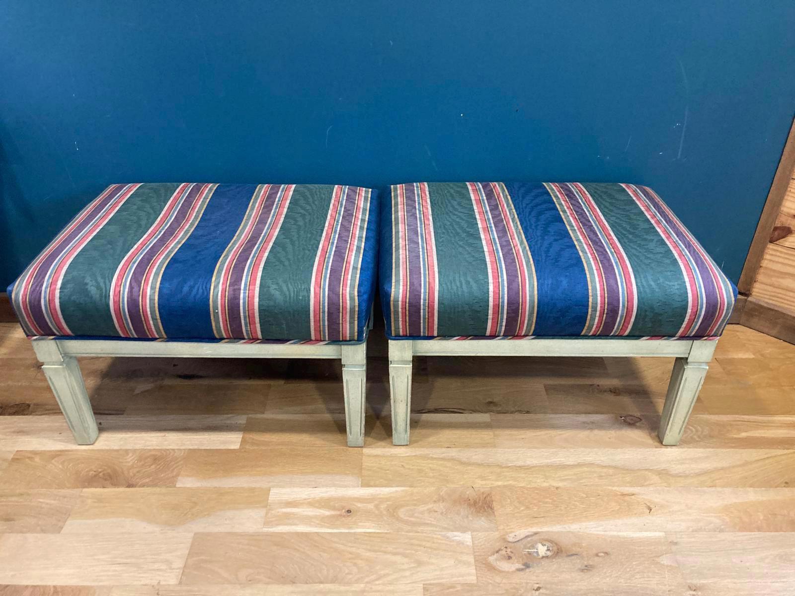 Two striped stools with a blue background