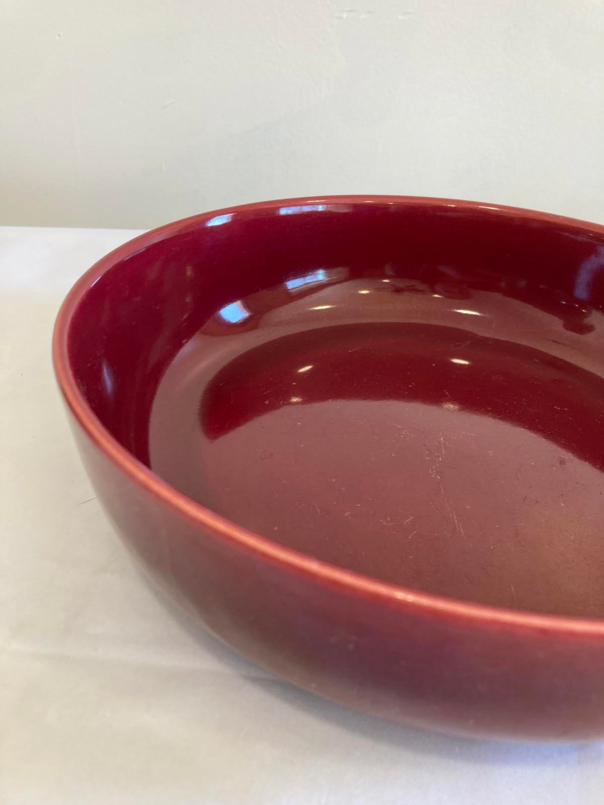 Red ceramic bowl on a white background
