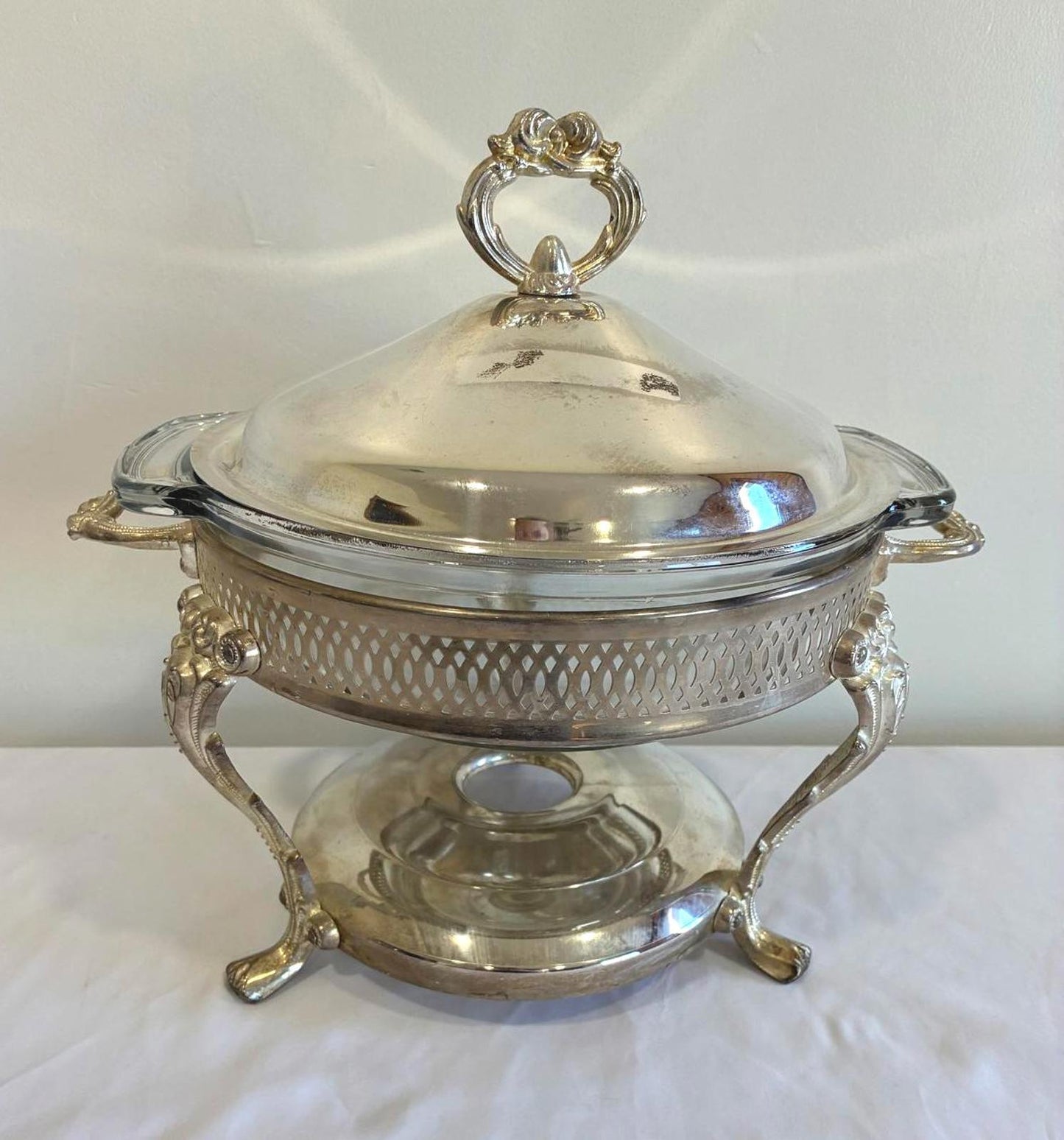 Silver chafing dish with lid on a white background
