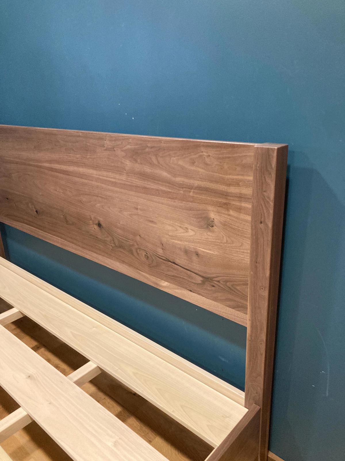 solid walnut Wooden headboard against a blue wall