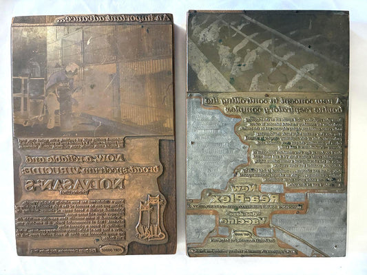 Pair of antique advertising letterpress printing plates mounted on wood blocks featuring metal printing surfaces with typography and image engraving, displaying authentic industrial patina and vintage printing history.